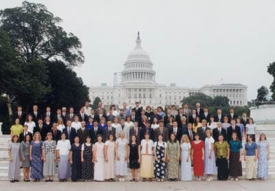 A group of people standing in front of the capitol building.